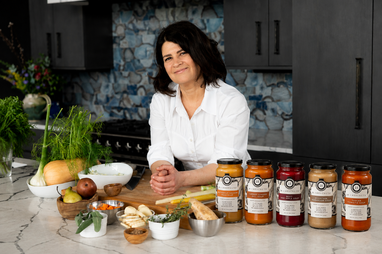 Ilona Kossoff in her kitchen behind a row of 18 Chestnuts jars