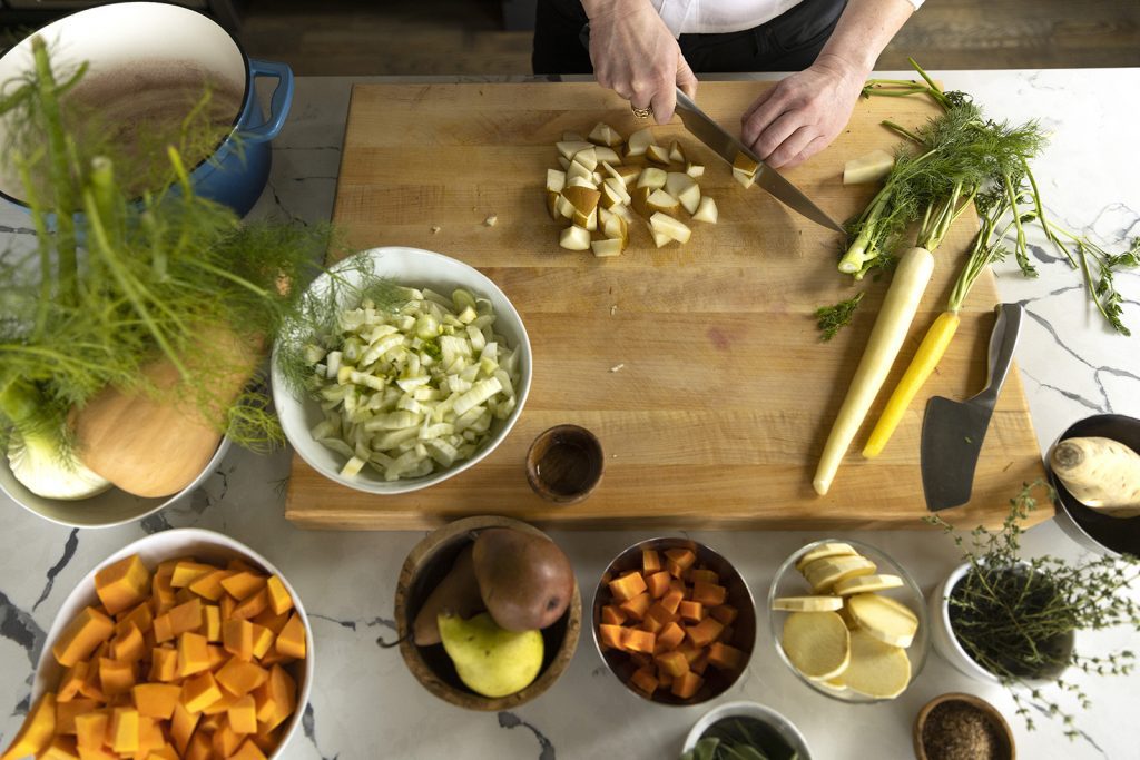 Herbs and vegetables on a wooden preparation board